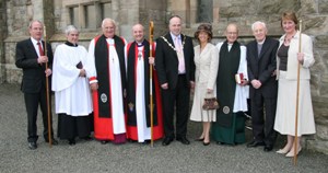 At the centenary service in St Colman’s Parish Church, Dunmurry on April 27 are, L to R:  Chris Cusdin (rector’s churchwarden), John Williams (parish reader), Lord Eames, the Rt Rev Alan Abernethy (Bishop of Connor), Councillor James Tinsley (Mayor), Mrs Margaret Tinsley (Mayoress), the Very Rev Hamilton Leckey (former Dean of Down), the Rev Canon Terry Rodgers (past rector) and Roberta Campbell (people’s churchwarden).